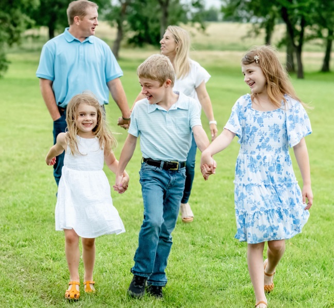 Lee and his family walk through a park.